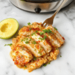 Colorful dish featuring tender shredded chicken glazed with glossy sweet Hawaiian sauce, garnished with chopped green onions on a white plate, with a backdrop of pineapple slices and cooked rice, styled in warm lighting highlighting the glossy sauce and vibrant garnish.